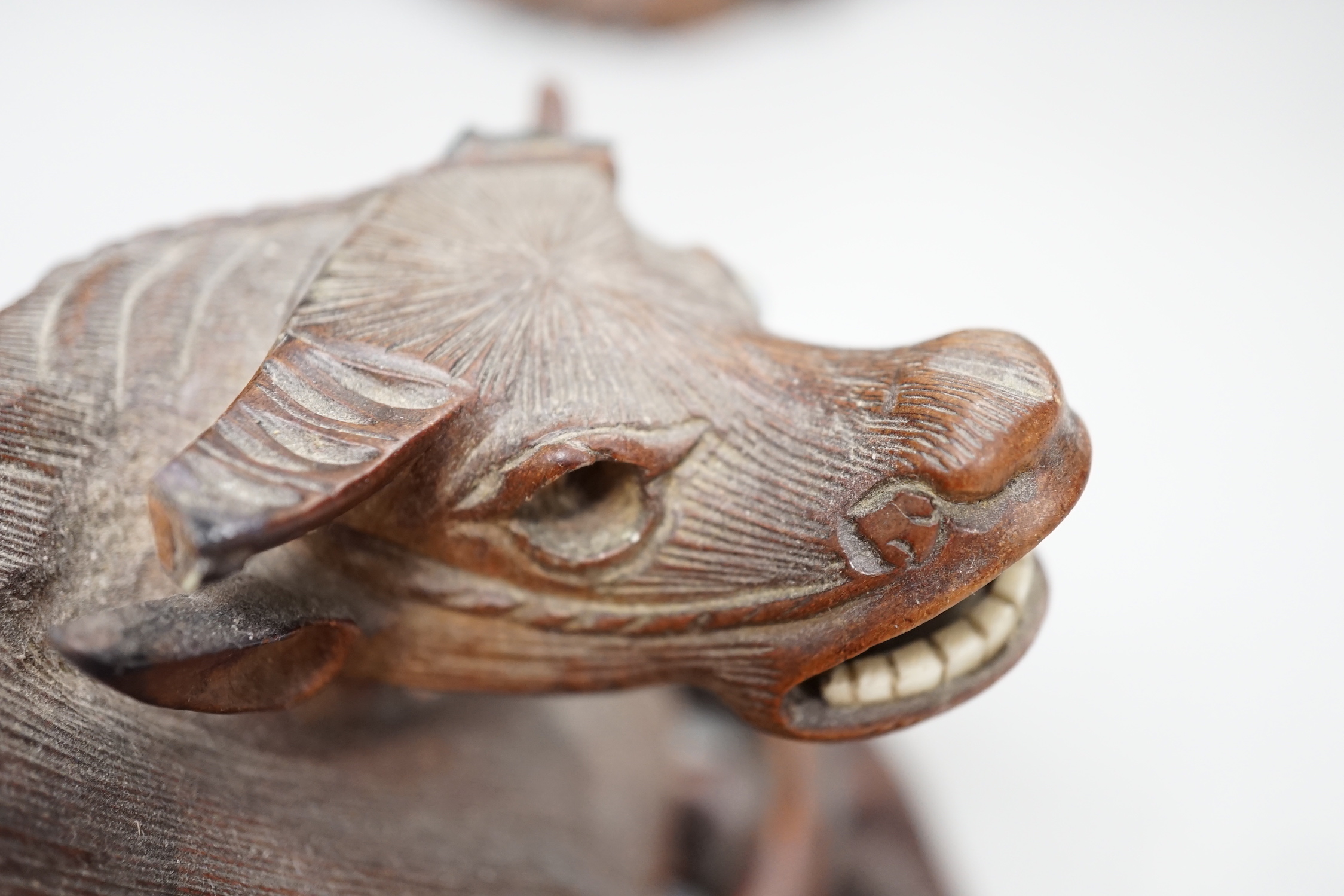 A pair of Chinese carved hardwood buffalo carvings, and a similar figure of a luohan, latter 24cm - damaged